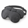 Charcoal weighted eye mask with curved bamboo fabric cover and adjustable strap on a white background.
