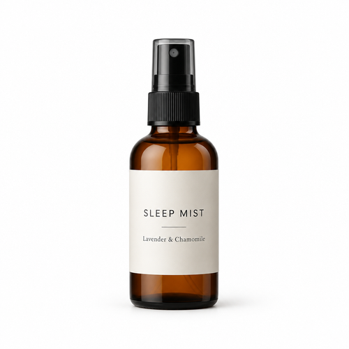Amber glass lavender and chamomile sleep mist bottle with a minimalist label and black spray pump on a white background.
